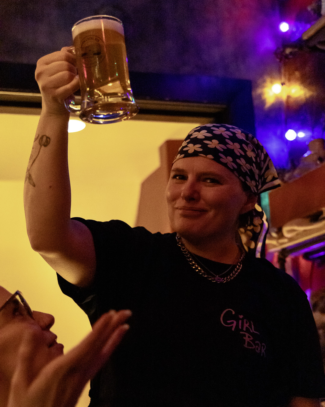a bartender raises a beer to a packed crowd during Girls Night at Union 613 in Ottawa
