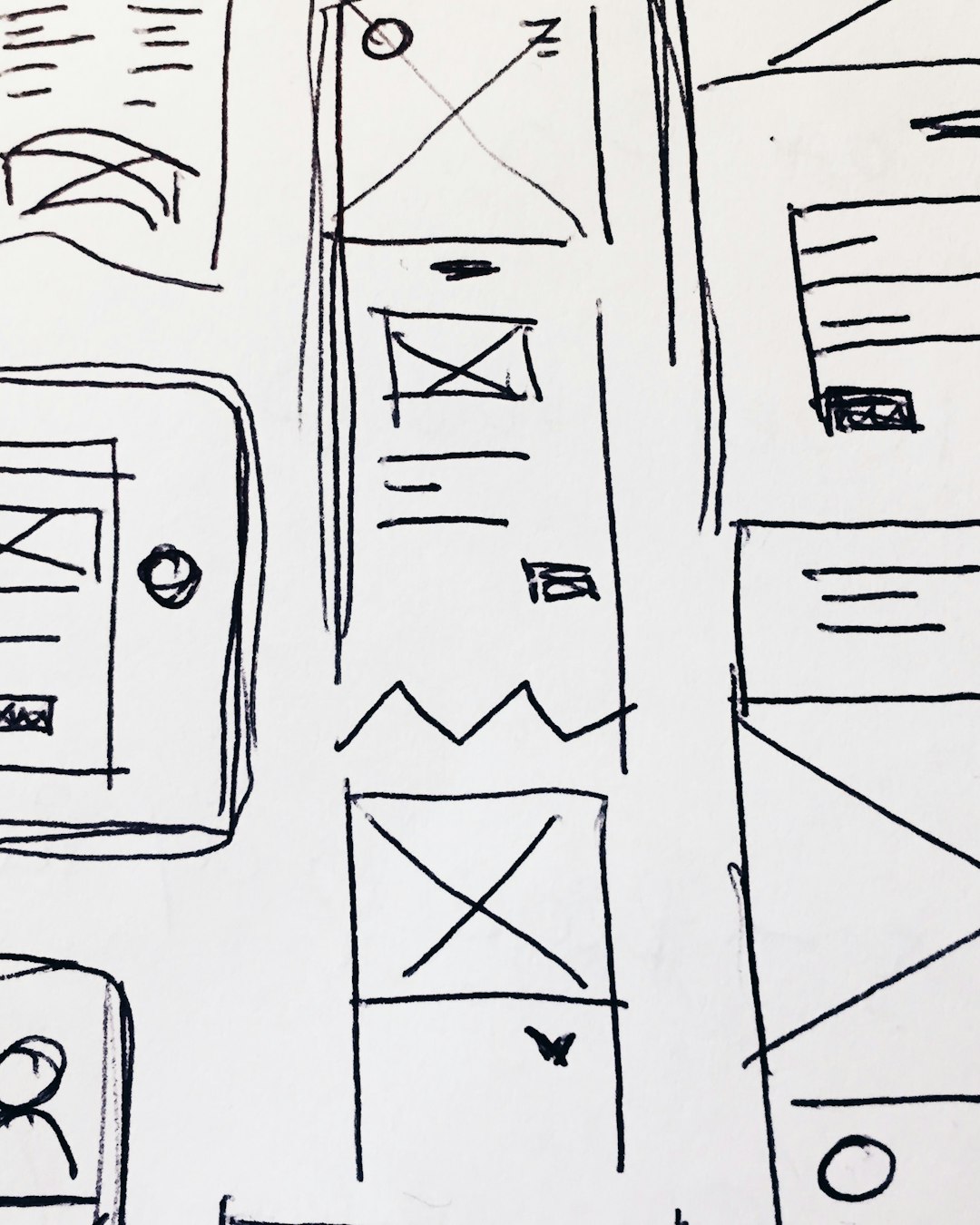 Hand-drawn website wireframe sketches on paper, planning a page layout redesign
